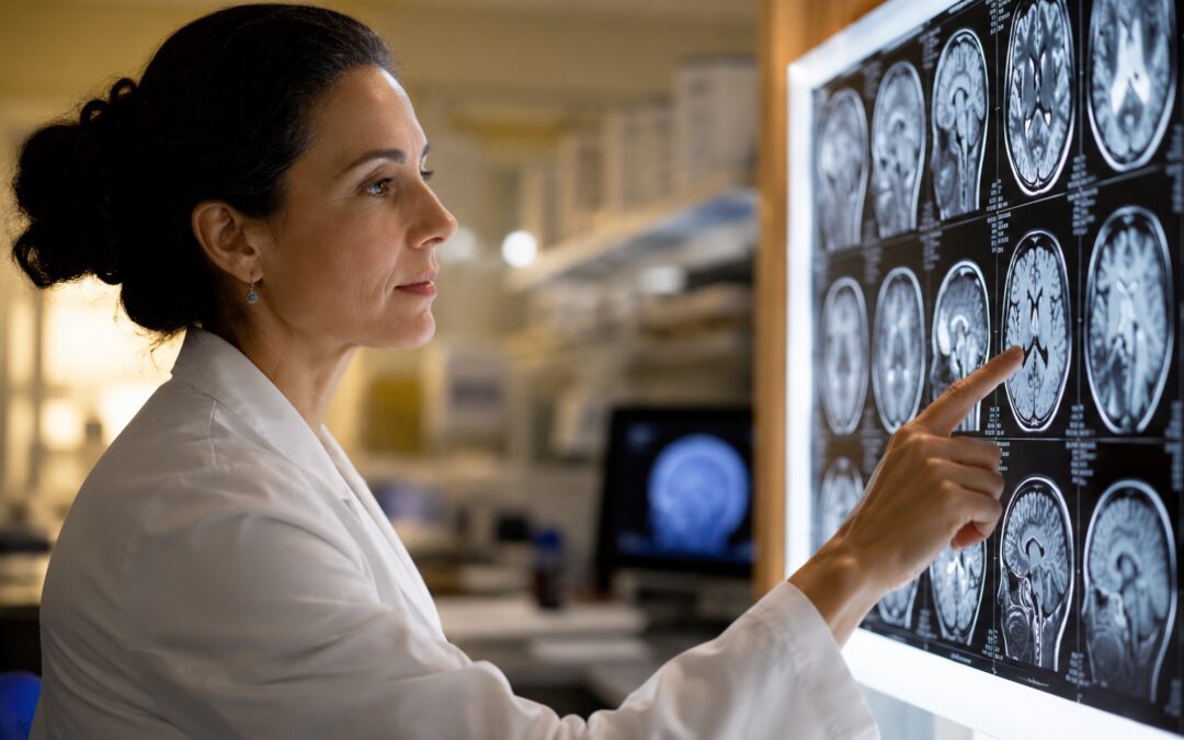 Medical Professional Reviewing Brain Scan Images On A Lightboard In A Clinical Laboratory Setting.