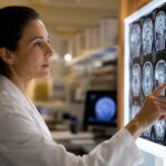 Medical Professional Reviewing Brain Scan Images On A Lightboard In A Clinical Laboratory Setting.
